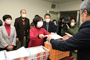 市に請求書と署名を提出する共同代表の池田さん（中央）